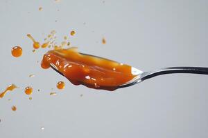 Caramel Sauce Splashing from a Spoon photo