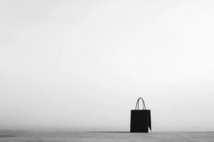 A Black Paper Bag Standing Alone on a Gray Surface photo