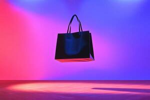 Black Tote Bag Floating Against a Pink and Blue Gradient Background photo