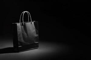 Black Paper Shopping Bag on Dark Background photo