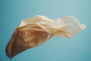 Flowing Beige Fabric Against a Blue Background photo