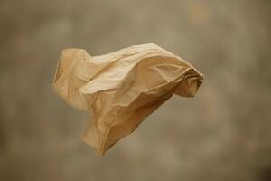 A Crumpled Brown Paper Bag Floating in Mid-Air photo