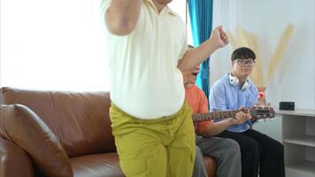 A family with an autistic child enjoys singing and dancing together at home during the holidays photo