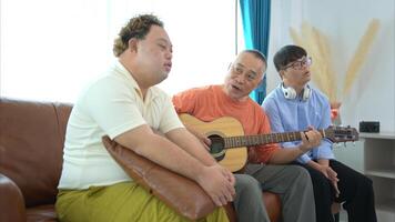 A family with an autistic child enjoys singing and dancing together at home during the holidays photo