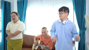 A family with an autistic child enjoys singing and dancing together at home during the holidays photo