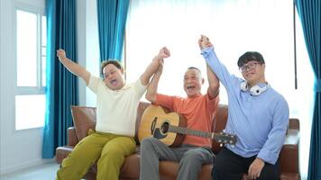 A family with an autistic child enjoys singing and dancing together at home during the holidays photo