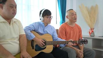 A family with an autistic child enjoys singing and dancing together at home during the holidays photo