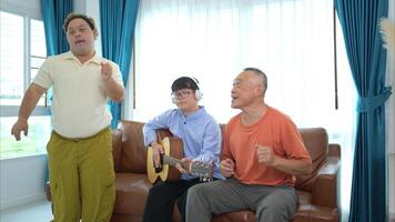 A family with an autistic child enjoys singing and dancing together at home during the holidays photo