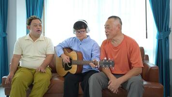 A family with an autistic child enjoys singing and dancing together at home during the holidays photo
