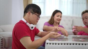 Three siblings save money by putting it in a piggy bank, This is an activity that parents teach their children about saving money photo
