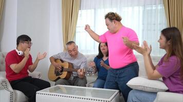 A grandfather with grandchild enjoys singing and dancing together at home during the holidays photo