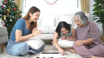 A family with an autistic child plays games together in the living room to relax during the holidays photo