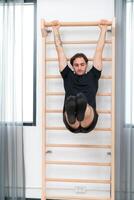 A young man doing cool down after pilates exercises class photo