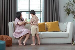 A special child and his mom having fun and relaxing on a holiday together in the living room of the house photo