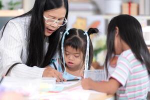 A group of special students doing learning activities in a special classroom photo
