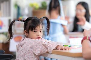 Portrait of special students doing learning activities in a special classroom photo