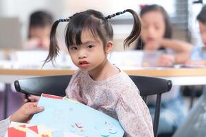 Portrait of special students doing learning activities in a special classroom photo