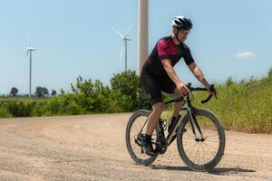 Cyclists are riding their bikes for training and touring the wind farms photo