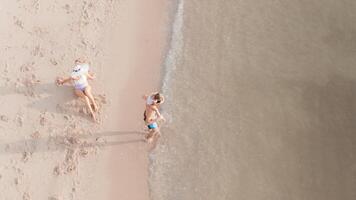 Top view of a family relaxing on the beach photo