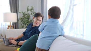 Father and son play together after dad comes home from work photo