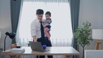 A business father and his duty to take care of his children while working photo