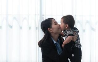 A business mother and his duty to take care of his children while working photo