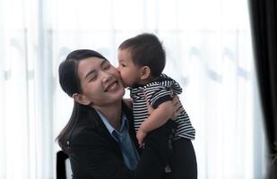 A business mother and his duty to take care of his children while working photo