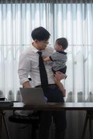 A business father and his duty to take care of his children while working photo