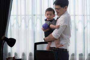 A business father and his duty to take care of his children while working photo
