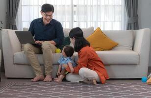 Parents and son play together after dad comes home from work photo