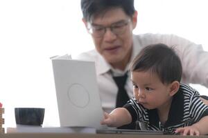 A business father and his duty to take care of his children while working photo