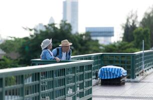 Elderly couples travel on the old iron bridge in Bangkok, Thailand photo