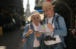 Elderly couples and their activities on the road at the end of the alley where there is a pagoda of Wat Arun, Thailand photo