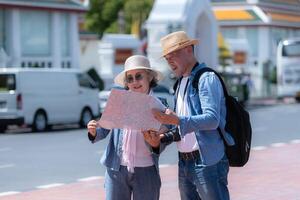 An elderly couple walks around the street in the old city of Bangkok, Thailand. photo