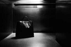 Black Paper Bag in a Dark Elevator photo