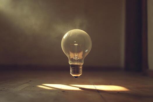 A Single Light Bulb Floating Above a Wooden Surface photo
