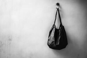 Black Plastic Bag Hanging on a Hook on a White Wall photo