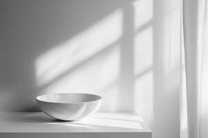 A White Bowl on a Shelf with a Window and Curtain in the Background photo