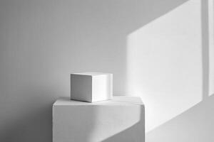 A White Cube on a White Platform Against a White Wall with Light and Shadow photo