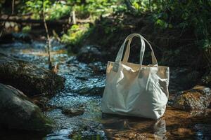 White Tote Bag Resting on a Creek Bed in a Forested Area photo