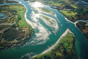 Aerial View of a Winding River Through Lush Green Forested Islands photo