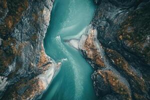 Aerial View of a Winding River Through a Mountain Gorge photo