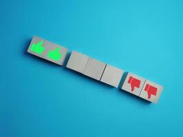 Like and dislike, thumbs up and down on empty wooden block photo