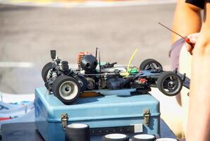 Setting up a radio-controlled car model with a gasoline engine. Motorsport, championship photo