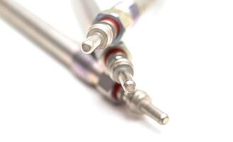 Modern ceramic glow plugs for warming up a diesel engine before starting. White background, isolate. Macro photo