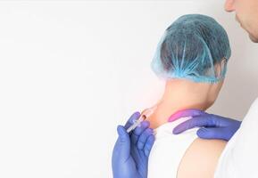 The doctor does a ganglionic medical blockade with medication to reduce pain and inflammation in the tissues of the spine. Modern method of treating neck diseases, copy space for text photo