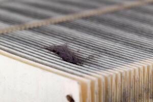 Dirty car air filter texture and background. Air filter element in a car engine, macro, damaged photo