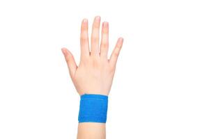 Blue elastic bandage on the wrist on a white background, isolate. Concept for fixation of the wrist joint for sports and avoidance of injuries, close-up photo
