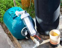 The system of modern water supply in a country house from a well source. Hydraulic accumulator for filling with water, sand filtration with filters. Industri photo