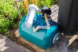 Water supply system with a hydraulic tank and a cleaning filter from a well in the country. photo